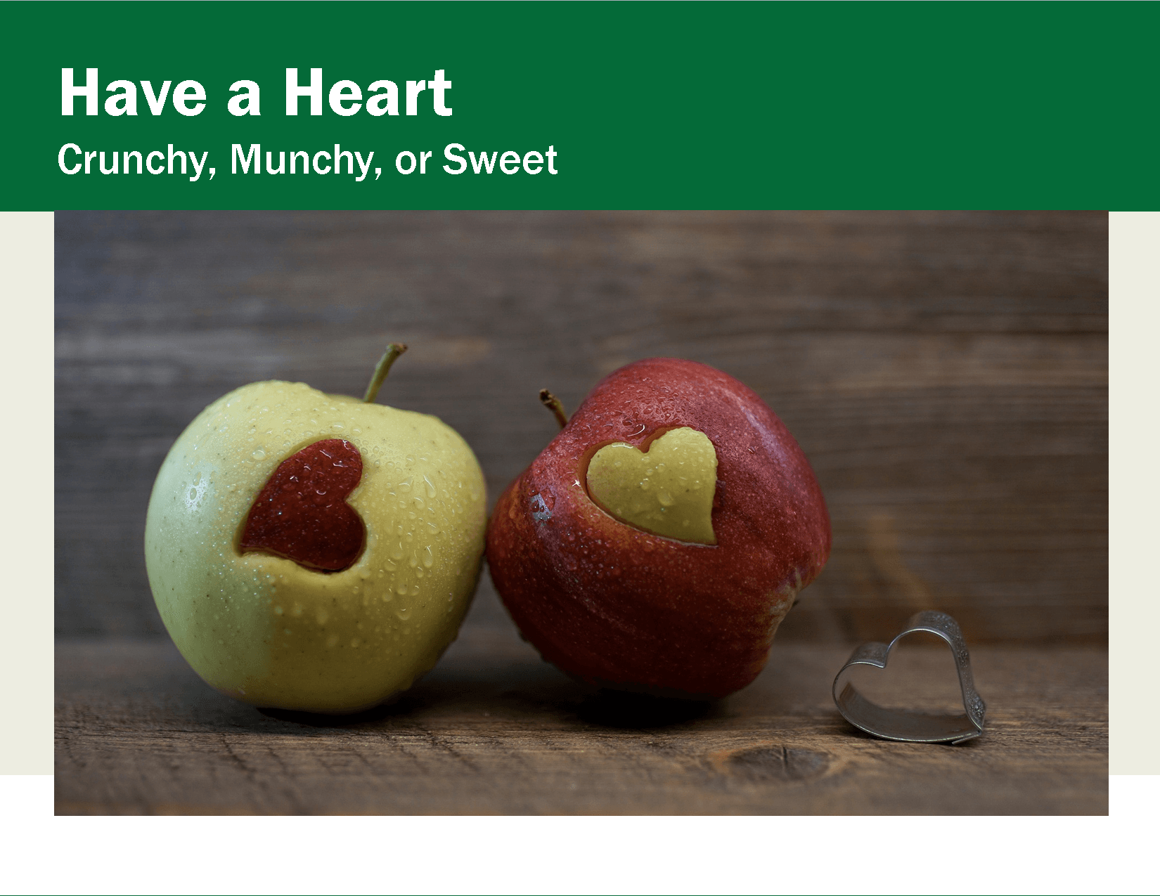 Red and green apple with heart shape cut out   